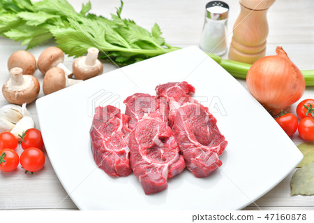 Image of ingredients, cooking, cooking and meat dishes. Beef sundae, celery, mushroom, onion, cherry tomatoes, garlic Image of ingredients, cooking, cooking and meat dishes. Beef sundae, celery, mushroom, onion, cherry tomatoes, garlic 47160878
