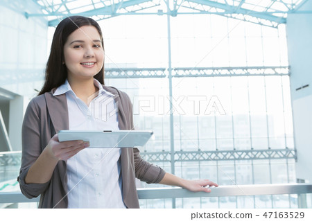 Attractive woman in office building Attractive woman in office building 47163529