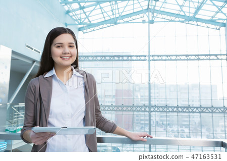 Attractive woman in office building Attractive woman in office building 47163531