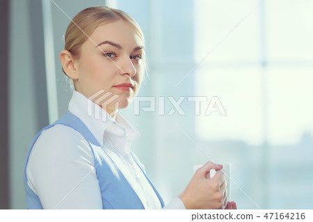 Attractive woman in office building Attractive woman in office building 47164216