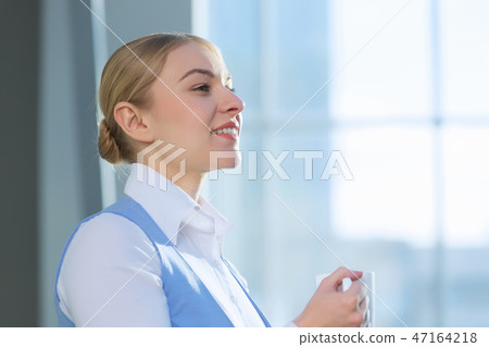 Attractive woman in office building Attractive woman in office building 47164218