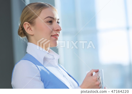 Attractive woman in office building Attractive woman in office building 47164220