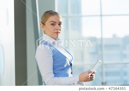 Attractive woman in office building Attractive woman in office building 47164301