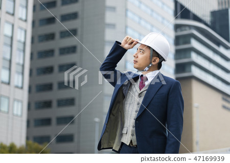 A businessman wearing a helmet A businessman wearing a helmet 47169939