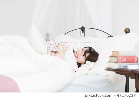 A woman on the bed 47170237