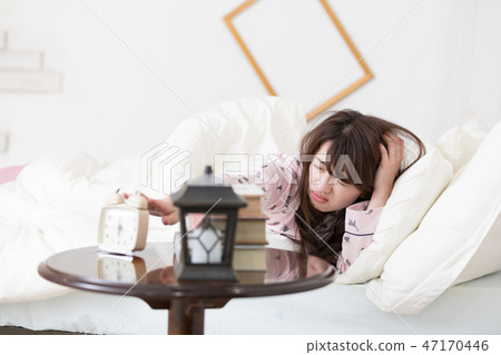 Woman stopping the alarm 47170446