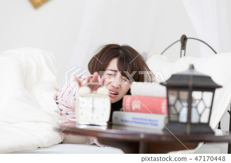 Woman stopping the alarm 47170448