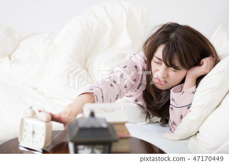 Woman stopping the alarm 47170449