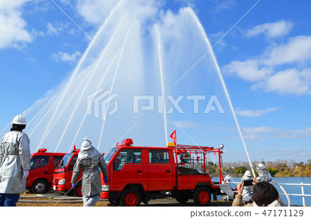 Firefighters and fire trucks demonstrating water discharge at the New Year's parade Firefighters and fire trucks demonstrating water discharge at the New Year's parade 47171129