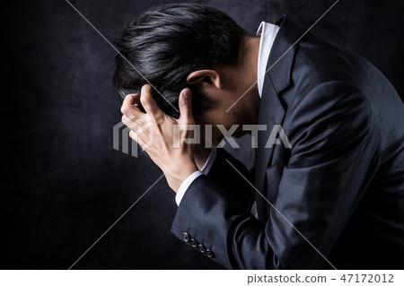 Businessman holding his head Businessman holding his head 47172012