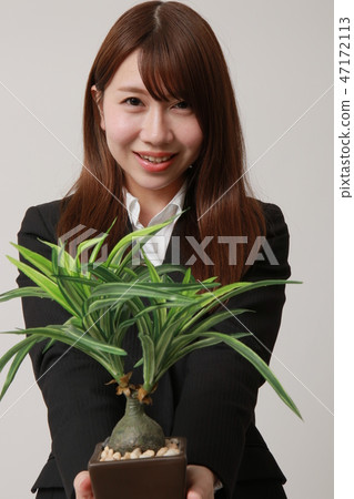 Young ol with houseplant Young ol with houseplant 47172113