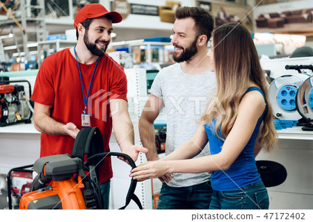 Couple of clients discussing blower with salesman Couple of clients discussing blower with salesman 47172402