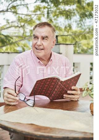 Positive senior man with book Positive senior man with book 47173032