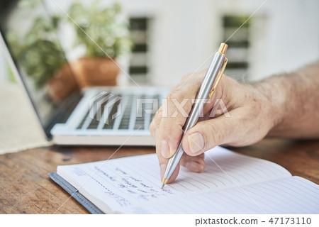 Aged man filling diary Aged man filling diary 47173110