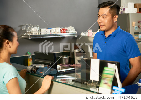 Talking to cashier Talking to cashier 47174613