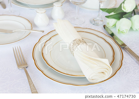 Luxurious porcelain, silverware and spring flowers Luxurious porcelain, silverware and spring flowers 47174730