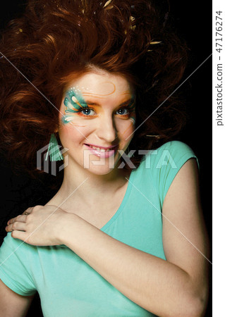 pretty funny girl with art make up, closeup floral print on face pretty funny girl with art make up, closeup floral print on face 47176274