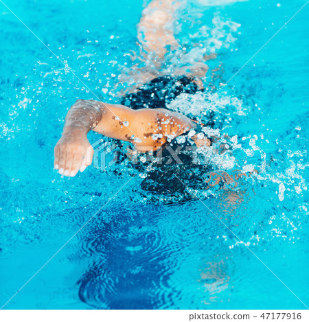 Front crawl swimmer in the pool 47177916