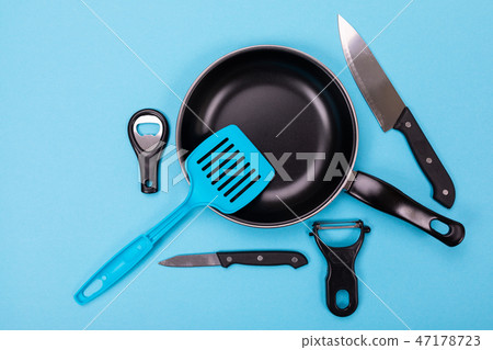 Close up picture of group of kitchen utensils with copyspace on blue background Close up picture of group of kitchen utensils with copyspace on blue background 47178723