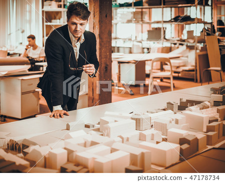 Confident engineer working in an architect studio Confident engineer working in an architect studio 47178734