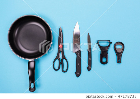 Close up picture of group of kitchen utensils with copyspace on blue background Close up picture of group of kitchen utensils with copyspace on blue background 47178735