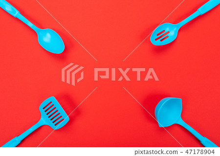 Close up picture of kitchen utensils with copyspace on red background Close up picture of kitchen utensils with copyspace on red background 47178904