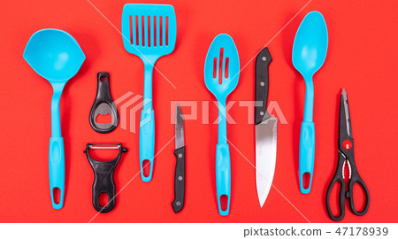Cooking utensils in kitchen isolated on red background 47178939