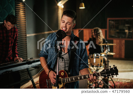 Music band having rehearsal in a studio 47179560