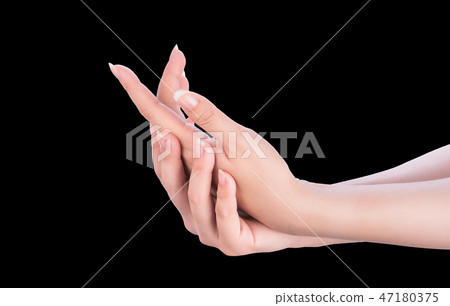 Female hand smear milk frost remedy dark skin black background Female hand smear milk frost remedy dark skin black background 47180375