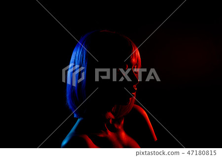 Woman in colorful bright lights posing in studio, portrait of beautiful sexy girl. 47180815