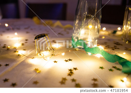 Champagne cap on the table between the lights. Champagne cap on the table between the lights. 47181954