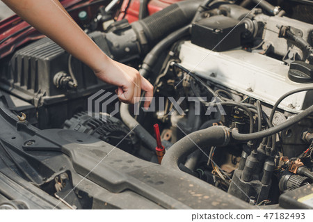 Beautiful girl hands open the car skirt to check  47182493