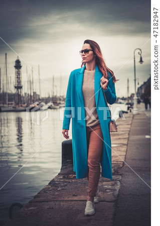 Beautifull woman walking the embankment 47182947