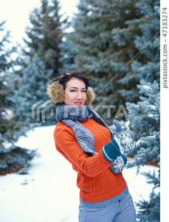 Woman is posing in winter forest Woman is posing in winter forest 47183274