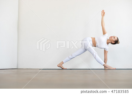 Sporty young woman doing yoga practice on white background. 47183585
