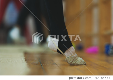 Close up of feet of young gymnast stretching Close up of feet of young gymnast stretching 47184357