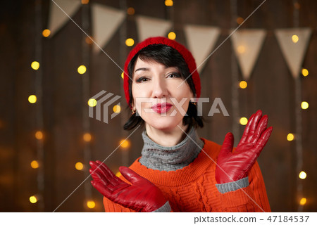 Beautiful woman is posing with red gloves Beautiful woman is posing with red gloves 47184537