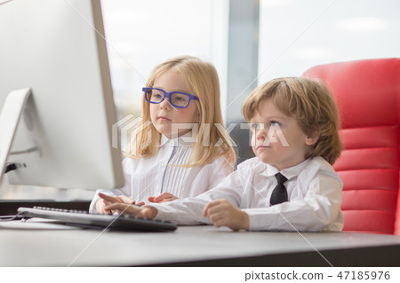 Little children on business meeting sharing ideas in office and using computer. 47185976