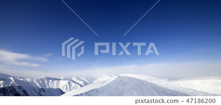 Panoramic view on snowy road in mountains Panoramic view on snowy road in mountains 47186200