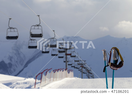 Snowy skiing slope, chair-lift and ski mask Snowy skiing slope, chair-lift and ski mask 47186201