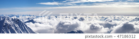 Panorama of snowy mountains covered with clouds Panorama of snowy mountains covered with clouds 47186312