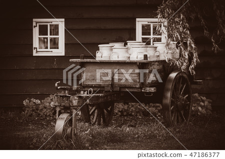 old traditional Dutch cans in a carriage in village old traditional Dutch cans in a carriage in village 47186377