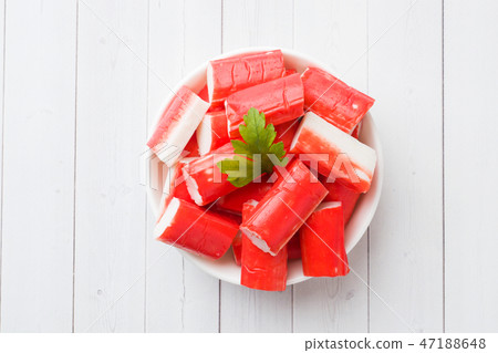 Salad crab sticks in a plate on a white table. Salad crab sticks in a plate on a white table. 47188648