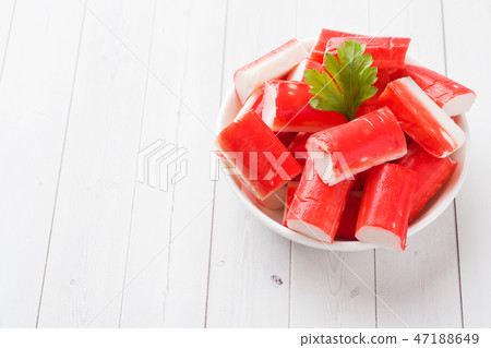 Salad crab sticks in a plate on a white table. Salad crab sticks in a plate on a white table. 47188649
