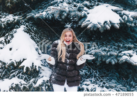 Winter young woman portrait. Beauty Joyful Model Girl laughing and having fun in winter park 47189055
