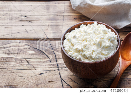 Homemade cottage cheese in a wooden bowl Homemade cottage cheese in a wooden bowl 47189084