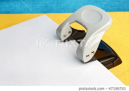Office punch and paper, mock up with copy space. Office punch and paper, mock up with copy space. 47190781