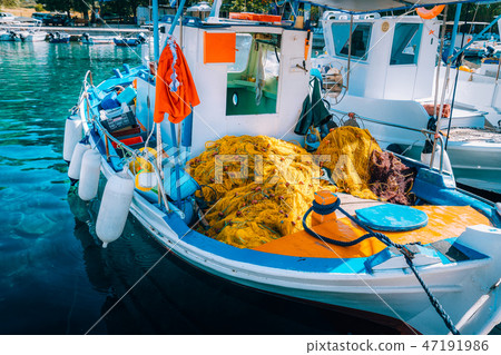Traditional colorful fishing boat in the sea, Greece. Sunny summer day Traditional colorful fishing boat in the sea, Greece. Sunny summer day 47191986