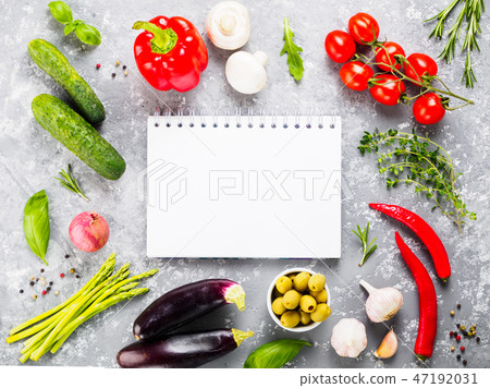 Notebook with vegetables and herbs on gray concrete background Notebook with vegetables and herbs on gray concrete background 47192031