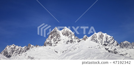 Panoramic view on snowy mountains and blue sky Panoramic view on snowy mountains and blue sky 47192342